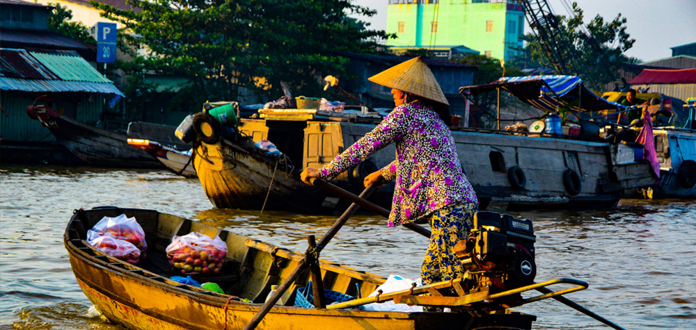 woman in a fishing boat, colorful surroundings