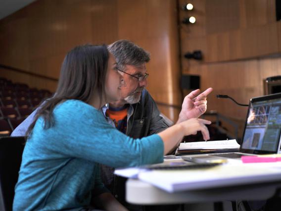 student and teacher working on laptop in classroom, University of Arizona, Tucson