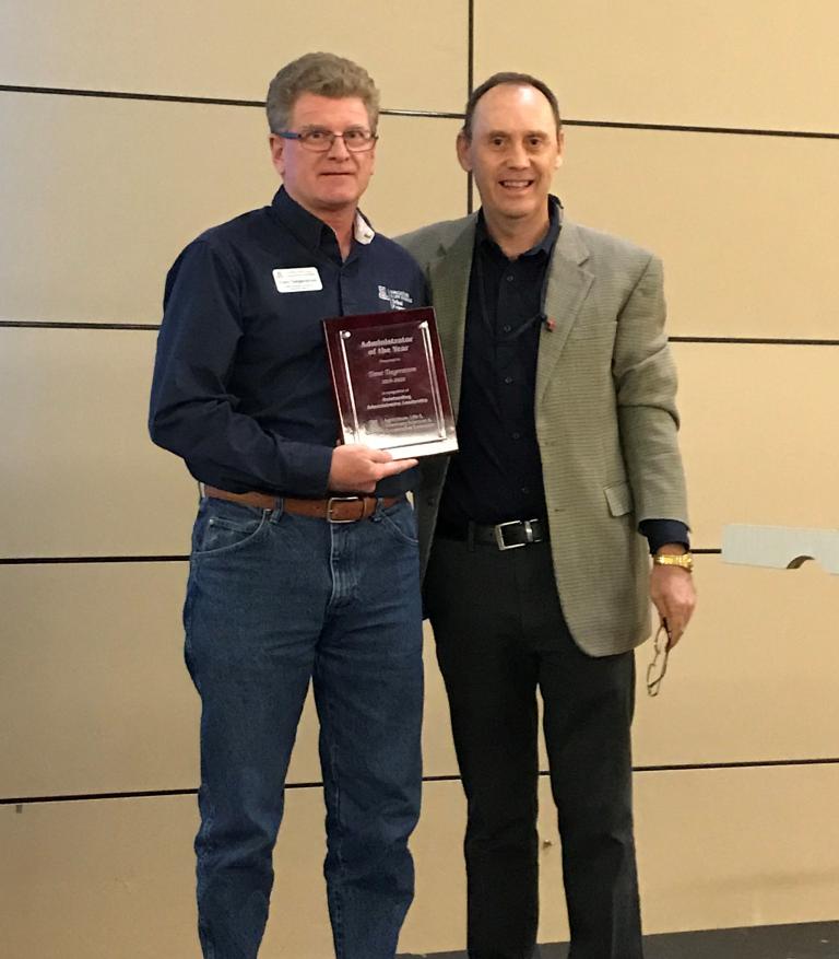 Trent holding the award along CALS' Dean Burgess